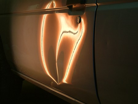 Before Paintless dent removal large dent on Nissan frontier door