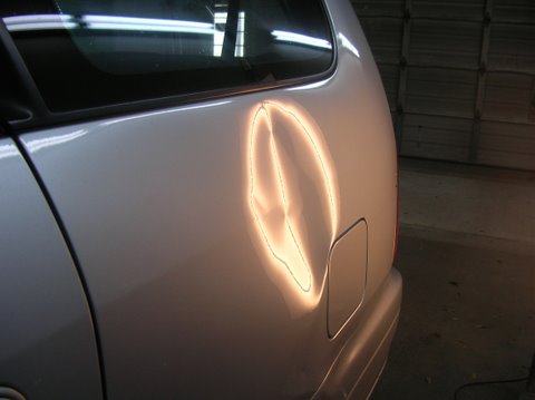 Dent on Honda Odyssey Quarter before repair