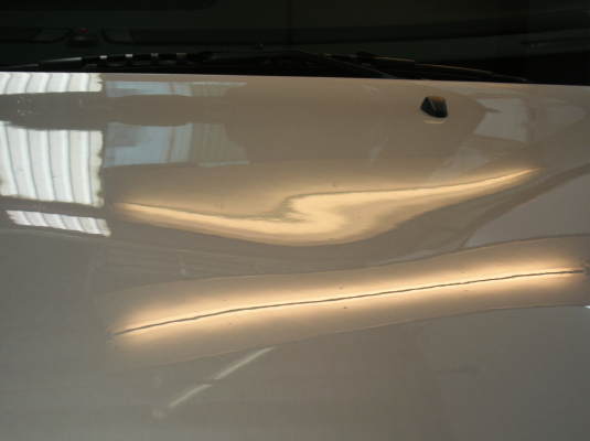 Large Area Waves- dents in Volvo hood before removal